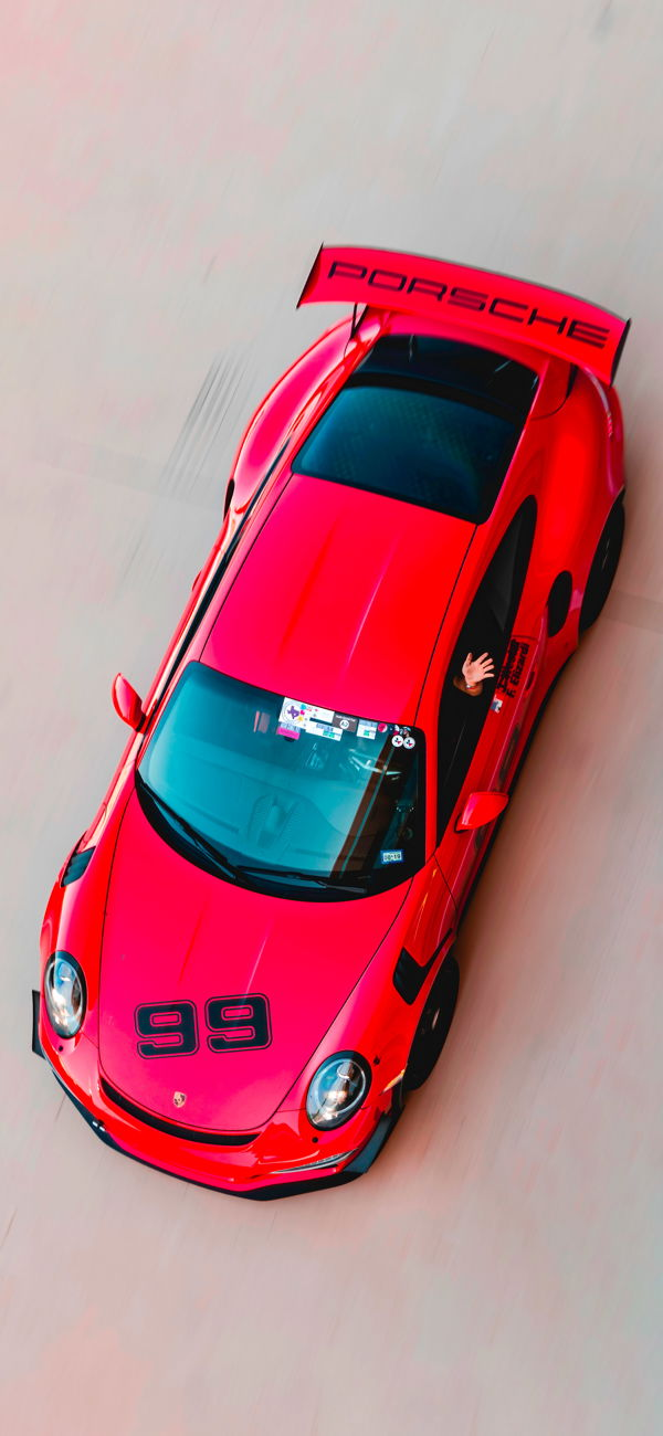 خلفية لقطة علوية لسيارة سباق بورش حمراء للجوال