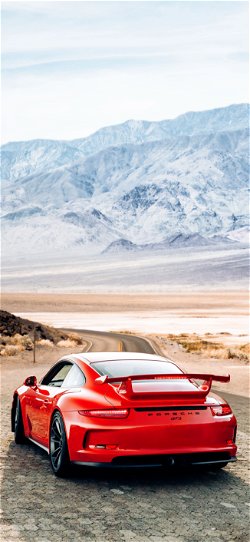 خلفية  سيارة بورش حمراء في وادي صخري  للجوال